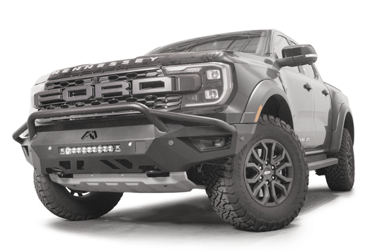 Fab Fours FR24-D6452-1 Vengeance Front Bumper with Pre-runner Guard installed on a 2024 Ford Ranger Raptor, featuring a high and tight fit, 11-gauge U.S. steel construction, matte black powder coat finish, and integrated mounts for a 20-inch LED light bar and dual cube lights.