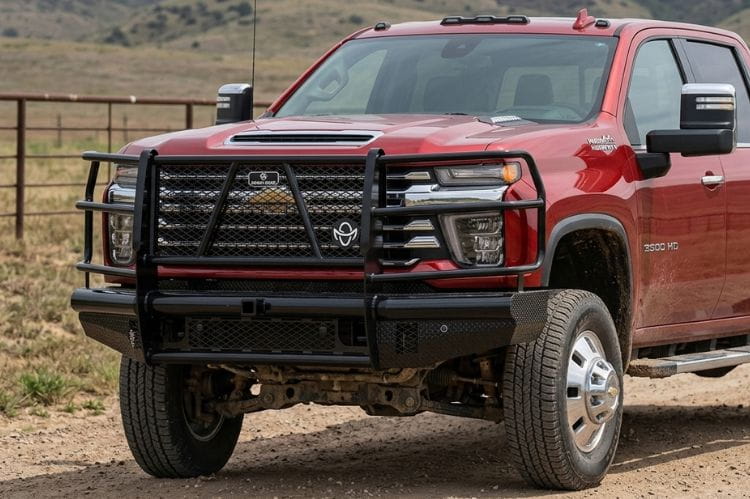 Ranch Hand FBC241BLR front bumper with grille guard for 2024–2026 Chevy Silverado 2500HD and 3500HD on a dirt road.