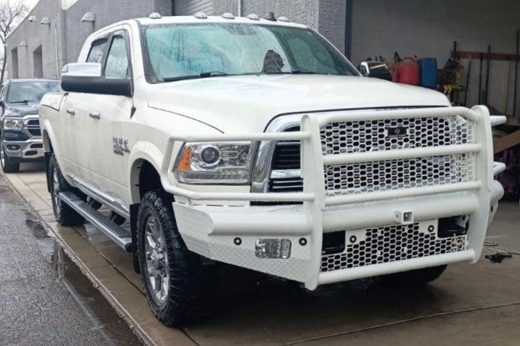 Ranch Hand FBD101BLRS Legend front bumper on white 2010-2018 Dodge Ram 2500 heavy duty truck on a wet road