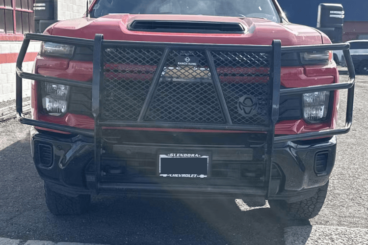 Red truck with Ranch Hand Legend Series Grille Guard GGC241BL1 installed on a 2024-2026 Chevy Silverado 2500HD 3500HD diesel truck in an outdoor setting