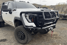 Road Armor Stealth 2242F2B Front Bumper with Titan II Guard installed on a 2024 GMC Sierra 2500 HD, featuring textured black finish, winch compatibility, and aggressive off-road styling.