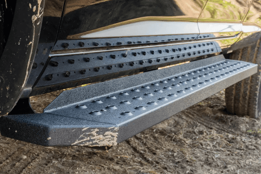 Steel Aries RidgeStep running boards with black finish for Dodge Ram 2500/3500 trucks.