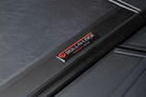 Roll-N-Lock M-Series 1999-2006 GMC Sierra 2500/3500 6.5' Tonneau Cover with Bedrail Caps LG208M