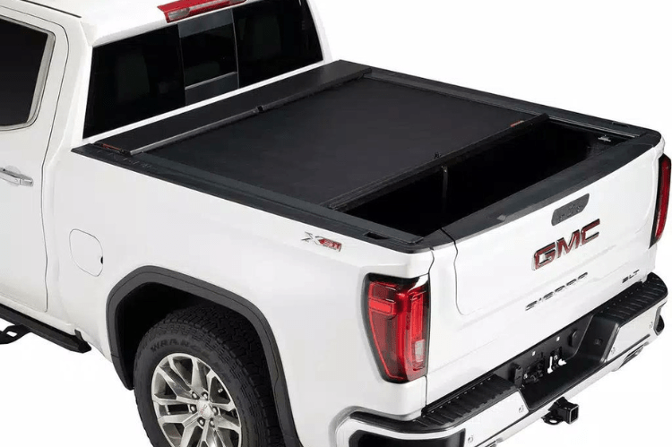 Roll-N-Lock M-Series 1999-2006 GMC Sierra 2500/3500 6.5' Tonneau Cover with Bedrail Caps LG208M