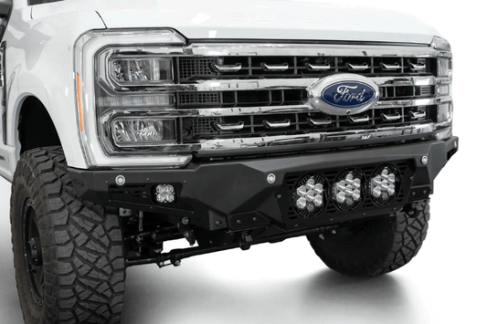 White truck front end showcasing a robust ADD Bomber Black bumper F810014100103, designed for Ford Superduty 2023-2025 models