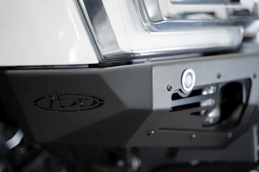 White truck front end showcasing a robust ADD Bomber Black bumper F810014100103, designed for Ford Superduty 2023-2025 models