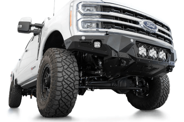 White truck front end showcasing a robust ADD Bomber Black bumper F810014100103, designed for Ford Superduty 2023-2025 models