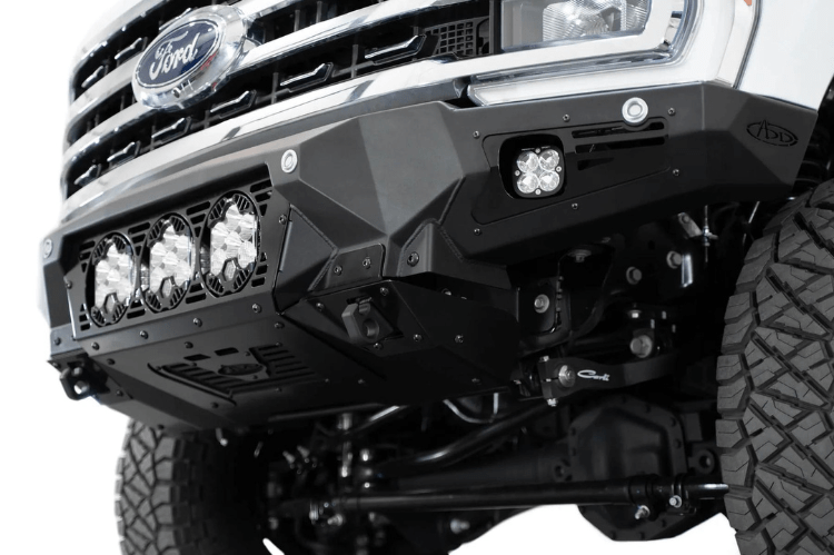 White truck front end showcasing a robust ADD Bomber Black bumper F810014100103, designed for Ford Superduty 2023-2025 models