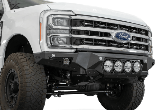 White truck's front end showcasing ADD Bomber Black bumper F810014110103, compatible with Ford Superduty models 2023-2025