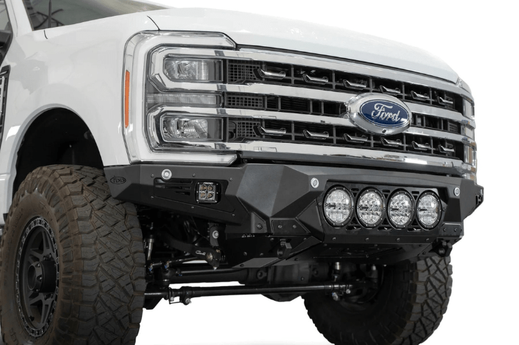 White truck's front end showcasing ADD Bomber Black bumper F810014110103, compatible with Ford Superduty models 2023-2025