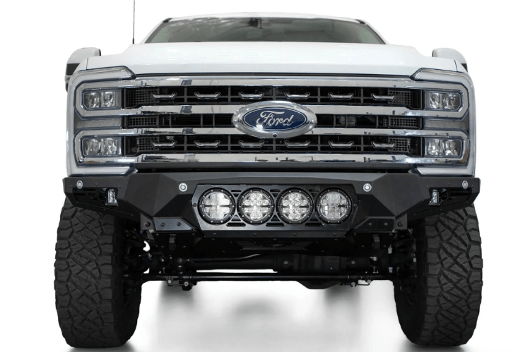 White truck's front end showcasing ADD Bomber Black bumper F810014110103, compatible with Ford Superduty models 2023-2025