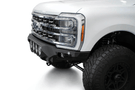 White truck's front end showcasing ADD Bomber Black bumper F810014110103, compatible with Ford Superduty models 2023-2025