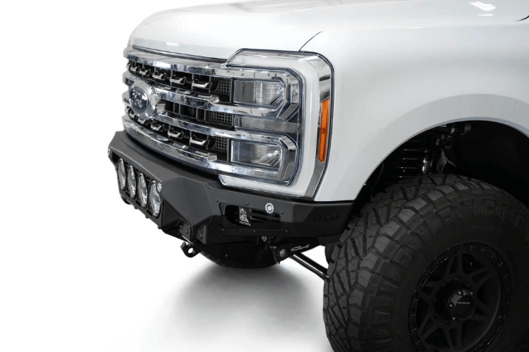 White truck's front end showcasing ADD Bomber Black bumper F810014110103, compatible with Ford Superduty models 2023-2025