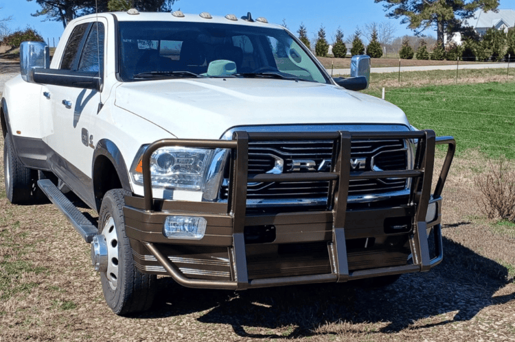 Ali Arc Classic front bumper for 2010-2018 Dodge Ram 2500 and 3500 trucks, featuring round fog light cut outs and rake style in an outdoor setting