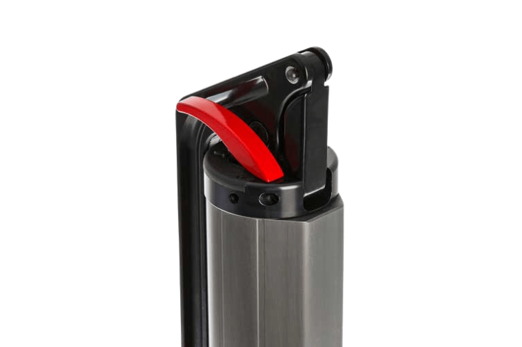 ARB hydraulic jack lifting a vehicle on uneven terrain, showing its rugged aluminum build and smooth hydraulic action.