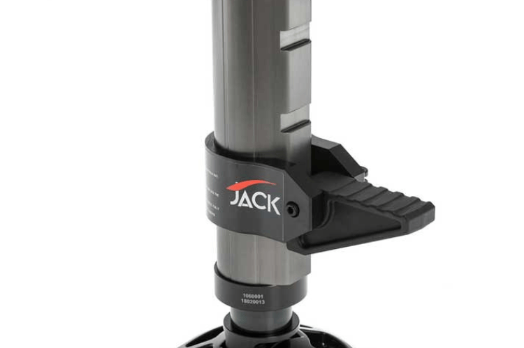 ARB hydraulic jack lifting a vehicle on uneven terrain, showing its rugged aluminum build and smooth hydraulic action.