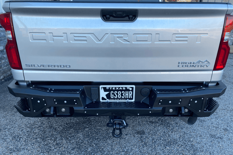 Aftermarket back bumper MFC20BYB for Chevy Silverado 2500/3500 with parking sensor cutouts and bare metal finish