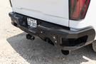 Aftermarket back bumper MFC20BYB for Chevy Silverado 2500/3500 with parking sensor cutouts and bare metal finish