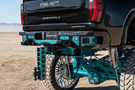 Aftermarket back bumper MFC20BYB for GMC Sierra 2500/3500 with parking sensor cutouts and bare metal finish