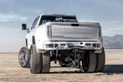 Aftermarket back bumper MFC20BYB for GMC Sierra 2500/3500 with parking sensor cutouts and bare metal finish