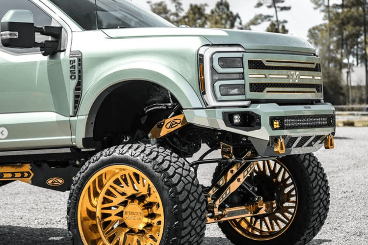 Front replacement bumper NAF23DYTNN with parking sensor cutouts installed on a 2023–2026 Ford F450 F550 Super Duty truck