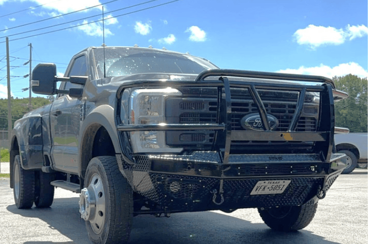 Bodyguard T2 Extreme front bumper guard for Ford Super Duty F450/F550, texture black finish with mesh grill, sensor cutouts, and winch mount skid plate.