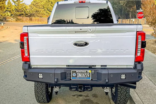Chassis Unlimited CUB990752 truck rear bumper on 2023+ Ford F250 F350 Super Duty steel bumper with recovery points and LED plate lights.