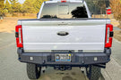 Chassis Unlimited CUB990752 truck rear bumper on 2023+ Ford F250 F350 Super Duty steel bumper with recovery points and LED plate lights.