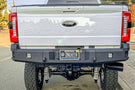 Chassis Unlimited CUB990752 truck rear bumper on 2023+ Ford F250 F350 Super Duty steel bumper with recovery points and LED plate lights.