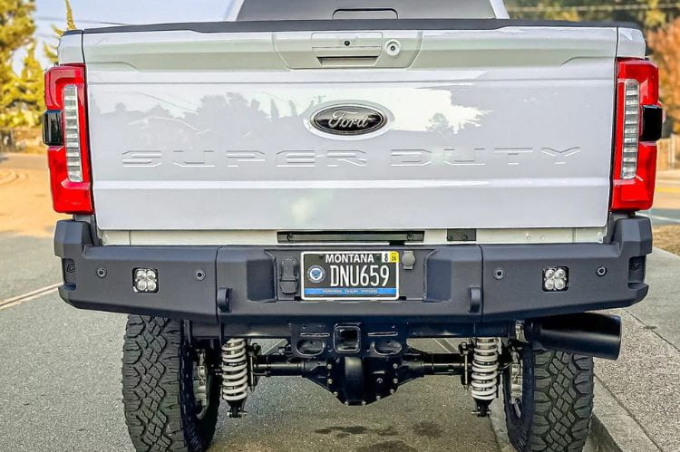 Chassis Unlimited CUB990752 truck rear bumper on 2023+ Ford F250 F350 Super Duty steel bumper with recovery points and LED plate lights.