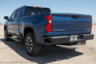 2025 Chevy Silverado 2500HD Complete Protection Kit with rugged Steelcraft bumpers and sleek AMP Research power steps