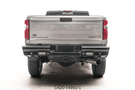 Upgraded 2023 GMC Sierra 2500HD featuring tough Fab Fours bumpers and sleek AMP Research steps