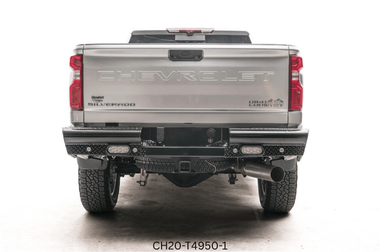Upgraded 2023 GMC Sierra 2500HD featuring tough Fab Fours bumpers and sleek AMP Research steps