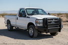 2016 F250 Super Duty outfitted with Fab Fours bumpers and Aries steps, giving the truck a tough, battle-ready look