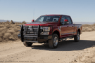 Bold 2022 Ford F250 equipped with Ranch Hand bumpers and Raptor Series steps for off-road and work-ready performance