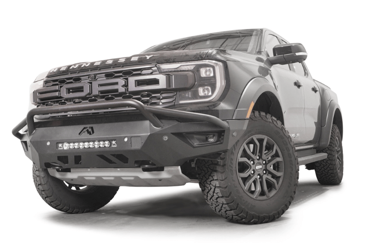 Fab Fours FR24-D6452-1 Vengeance Front Bumper with Pre-runner Guard installed on a 2024 Ford Ranger Raptor, featuring a high and tight fit, 11-gauge U.S. steel construction, matte black powder coat finish, and integrated mounts for a 20-inch LED light bar and dual cube lights.