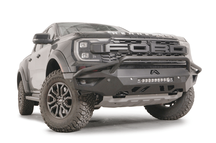 Fab Fours FR24-D6452-1 Vengeance Front Bumper with Pre-runner Guard installed on a 2024 Ford Ranger Raptor, featuring a high and tight fit, 11-gauge U.S. steel construction, matte black powder coat finish, and integrated mounts for a 20-inch LED light bar and dual cube lights.