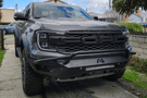 Fab Fours FR24-D6452-1 Vengeance Front Bumper with Pre-runner Guard installed on a 2024 Ford Ranger Raptor, featuring a high and tight fit, 11-gauge U.S. steel construction, matte black powder coat finish, and integrated mounts for a 20-inch LED light bar and dual cube lights.