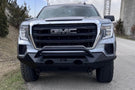 Fab Fours GS19-X3952-1 Matrix Series Front Bumper with Pre-Runner Guard for 2019-2022 GMC Sierra 1500, Winch Ready Slim Steel Bumper parked on a gravel surface with a dark background