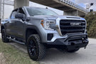 Fab Fours GS19-X3952-1 Matrix Series Front Bumper with Pre-Runner Guard for 2019-2022 GMC Sierra 1500, Winch Ready Slim Steel Bumper parked on a gravel surface with a dark background