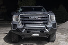 Fab Fours GS19-X3952-1 Matrix Series Front Bumper with Pre-Runner Guard for 2019-2022 GMC Sierra 1500, Winch Ready Slim Steel Bumper parked on a gravel surface with a dark background