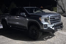 Fab Fours GS19-X3952-1 Matrix Series Front Bumper with Pre-Runner Guard for 2019-2022 GMC Sierra 1500, Winch Ready Slim Steel Bumper parked on a gravel surface with a dark background