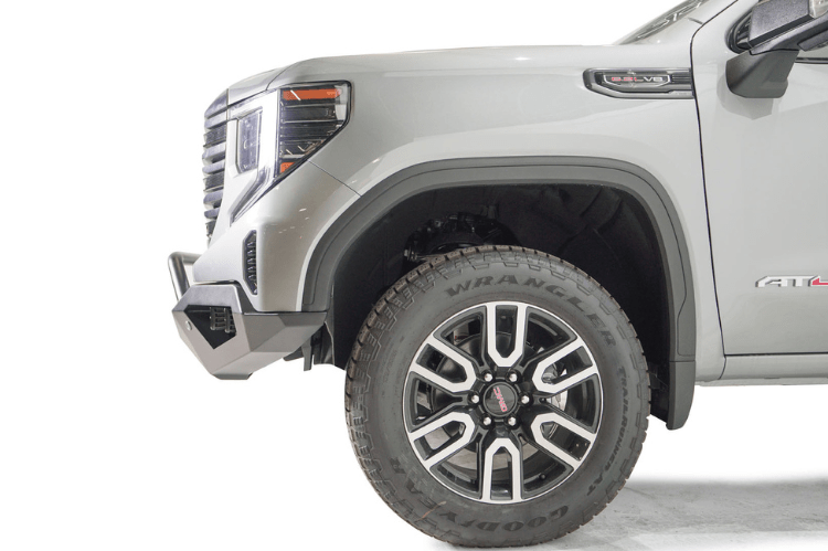 Silver GMC Sierra 1500 truck's front end showcasing a black Fab Fours Vengeance bumper guard