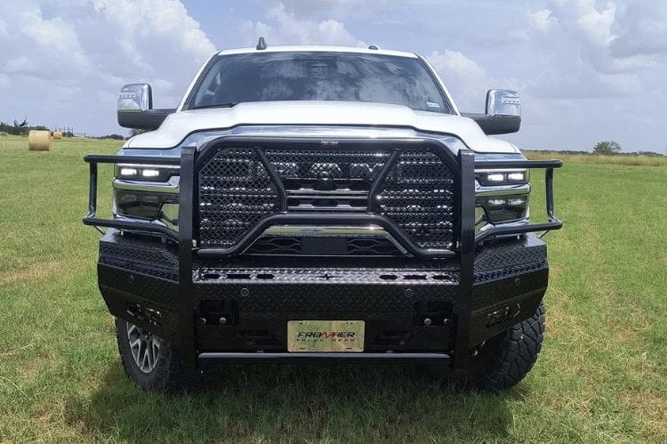 White truck with Frontier Original Series Front Bumper Replacement for 2025 Dodge Ram 2500 and 3500, heavy-duty brush guard style in a grassy field