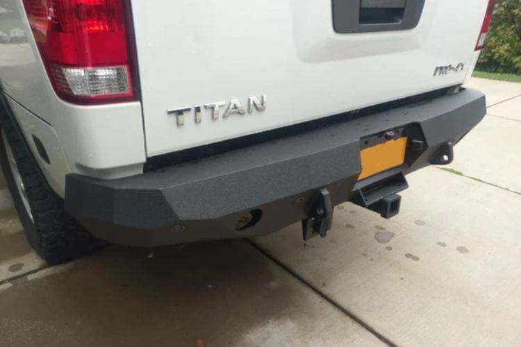 Aftermarket rear bumper #42 by Iron Bull is mounted on the back end of a 2004-2015 Nissan Titan pickup truck