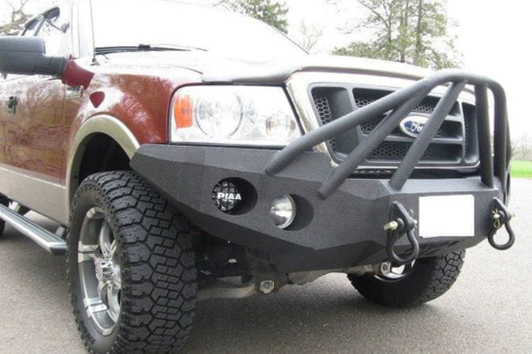 Heavy duty front bumper #21 by Iron Bull displays a black steel finish on a 2004-2008 Ford F150 rugged work truck 