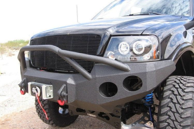 Heavy duty front bumper #21 by Iron Bull displays a black steel finish on a 2004-2008 Ford F150 rugged work truck 