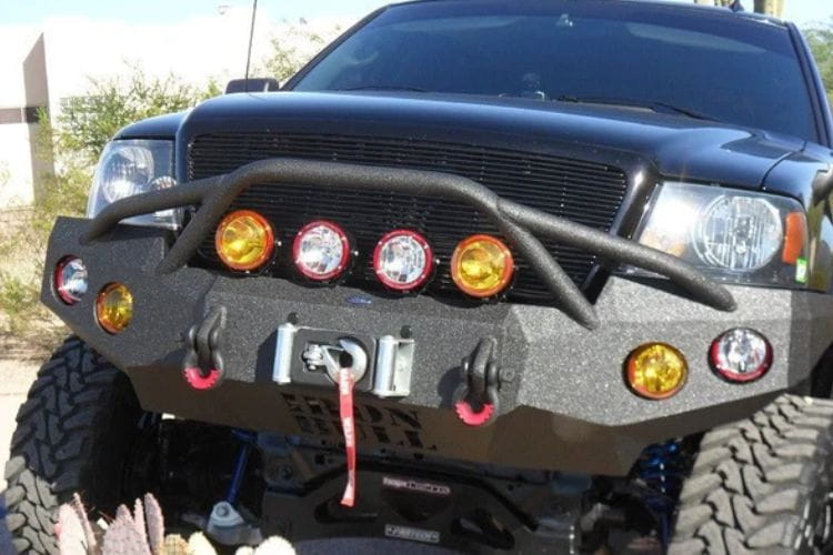 Heavy duty front bumper #21 by Iron Bull displays a black steel finish on a 2004-2008 Ford F150 rugged work truck 