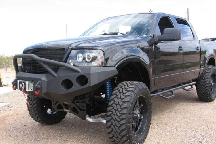 Heavy duty front bumper #21 by Iron Bull displays a black steel finish on a 2004-2008 Ford F150 rugged work truck 
