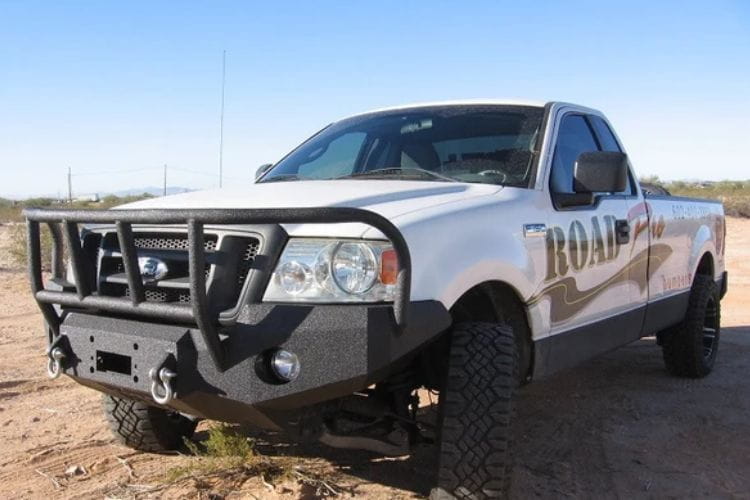 Heavy duty front bumper #21 by Iron Bull displays a black steel finish on a 2004-2008 Ford F150 rugged work truck 